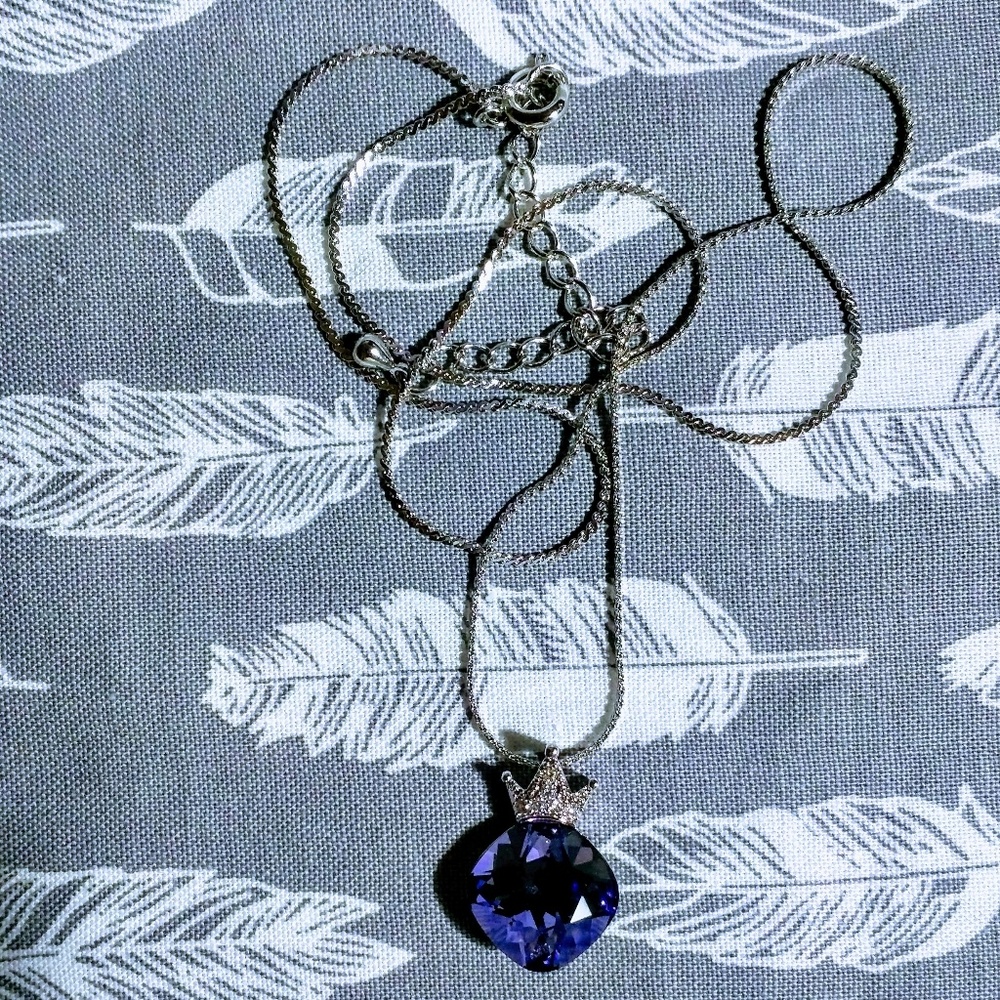 Rounded square cut purple gem with a crystal crown